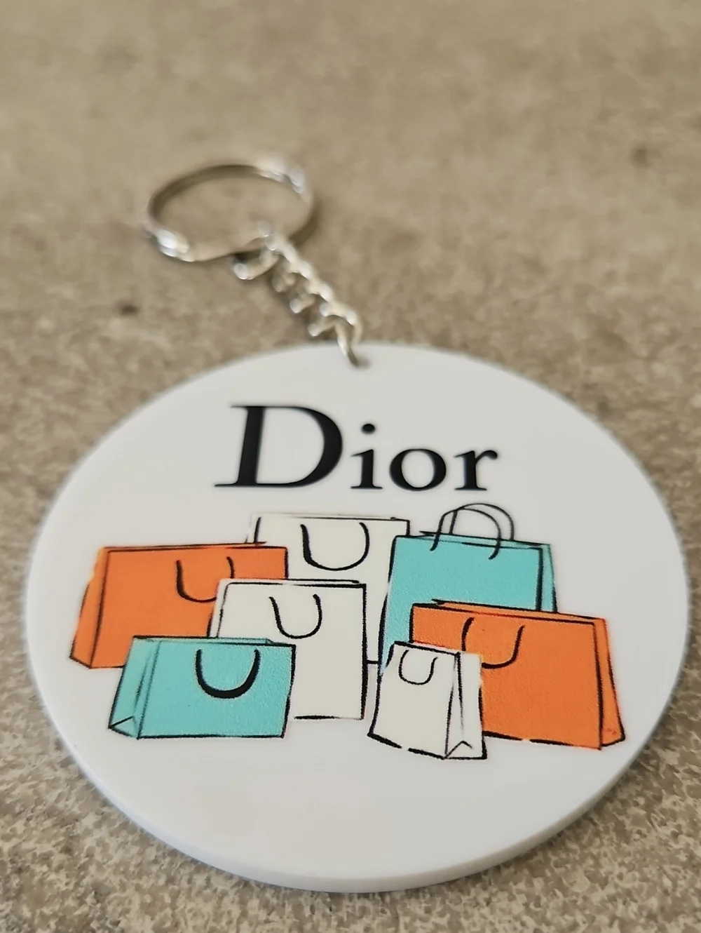 Fashion White Round Key chain with Orange, Teal and Cream Shopping Bags - Picture 2 of 3